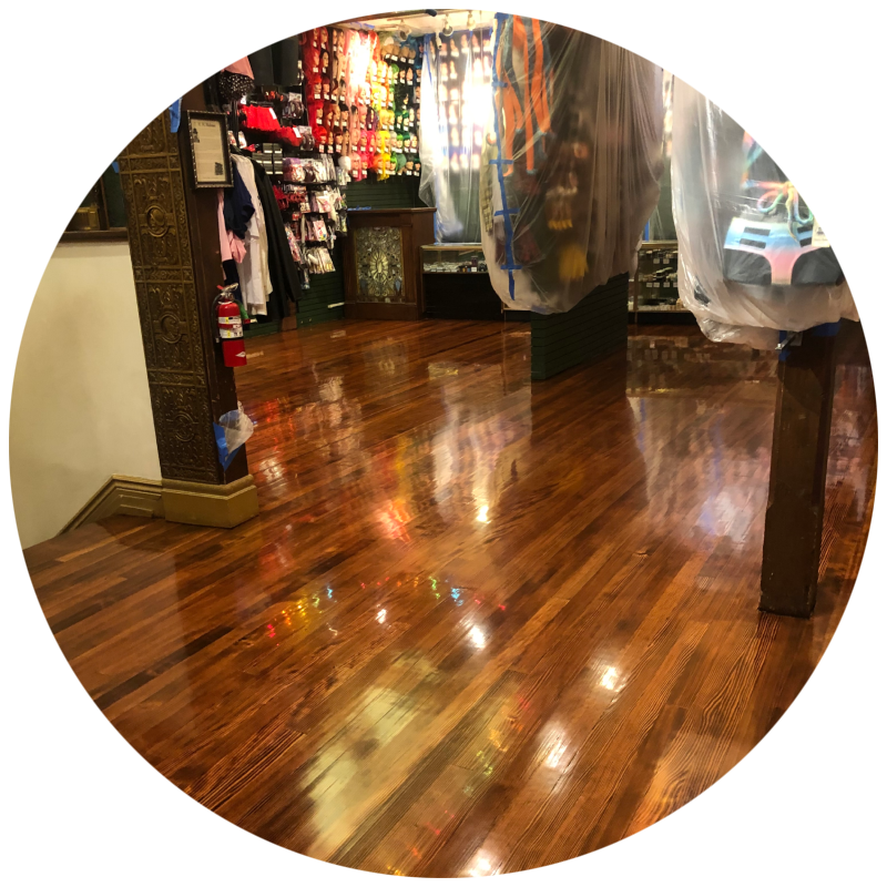 best Hardwood floor refinishing near me Hardwood floor refinishing - A large room with a newly sanded maple wood floor, showing the light wood grain