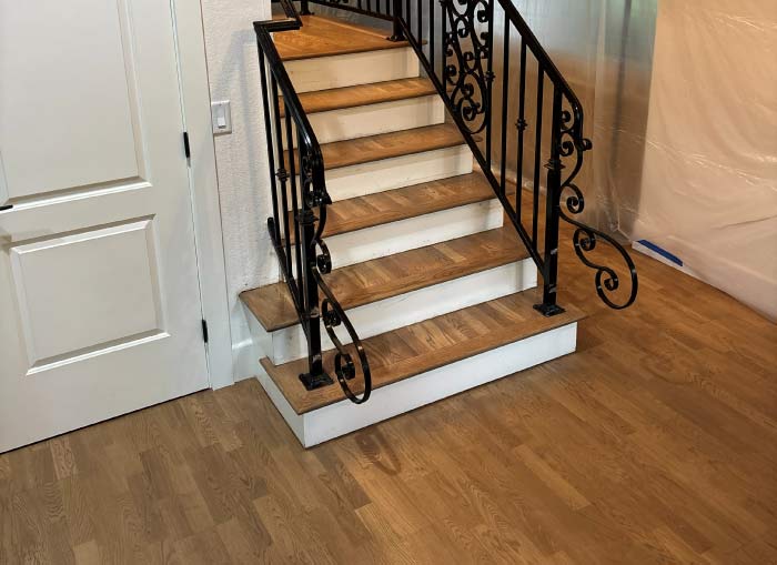 Detailed view of complex Staircase Installation with solid hardwood, a labor-intensive factor that affects the total project cost calculation.