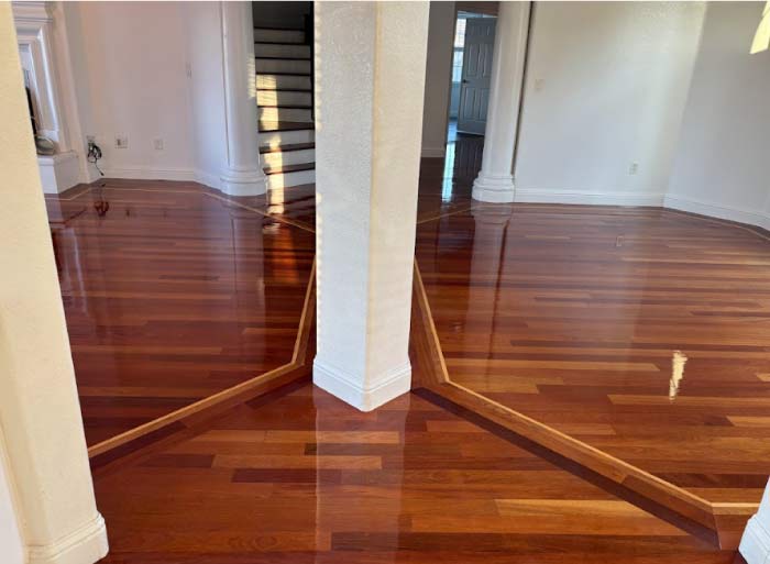 Elegant dark-stained solid hardwood floors after installation, showcasing a rich, luxurious, and durable finish for high-traffic areas.