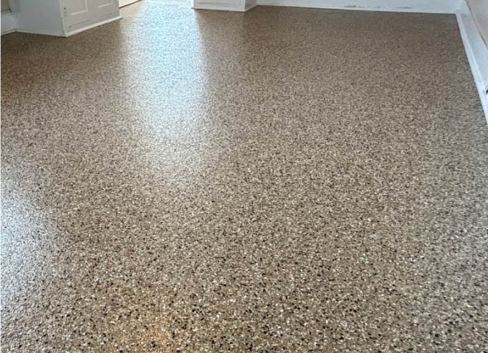 High-quality, glossy brown flake epoxy floor in a newly finished interior utility space