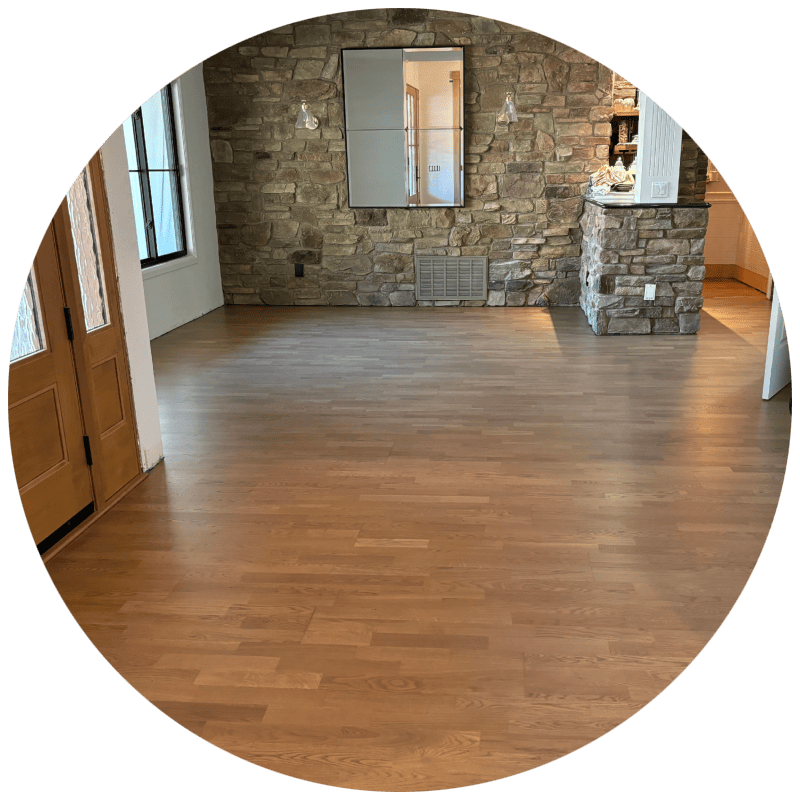 LVP flooring installation - A room with a large area of newly installed light-colored hardwood flooring