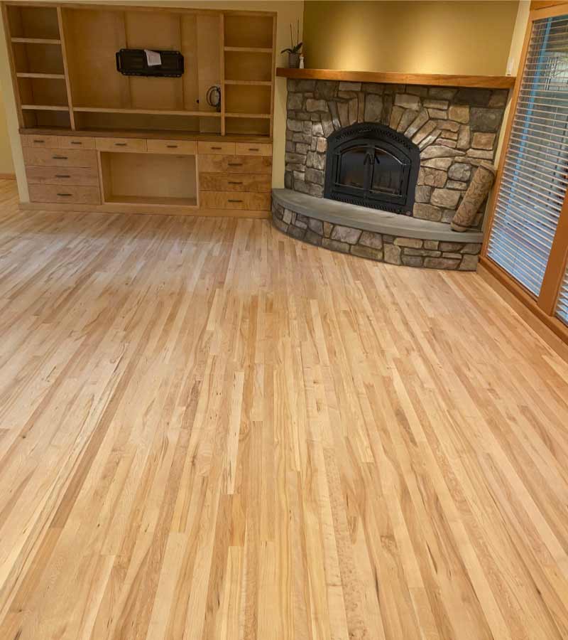living room with coy fire pit with laminate hardwood flooring